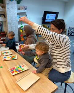 Playing with plastic monkeys at Concord Cubs class