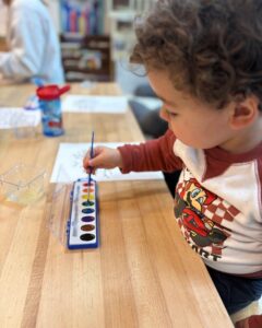 Preschool boy playing with paints