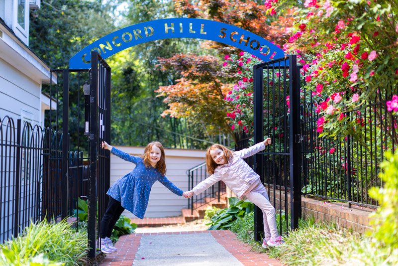 Girls posing in front of the Concord Hill gate